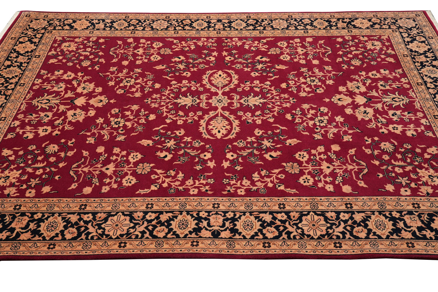 Sarouk-pattern wool rug, curvilinear floral detail on black field