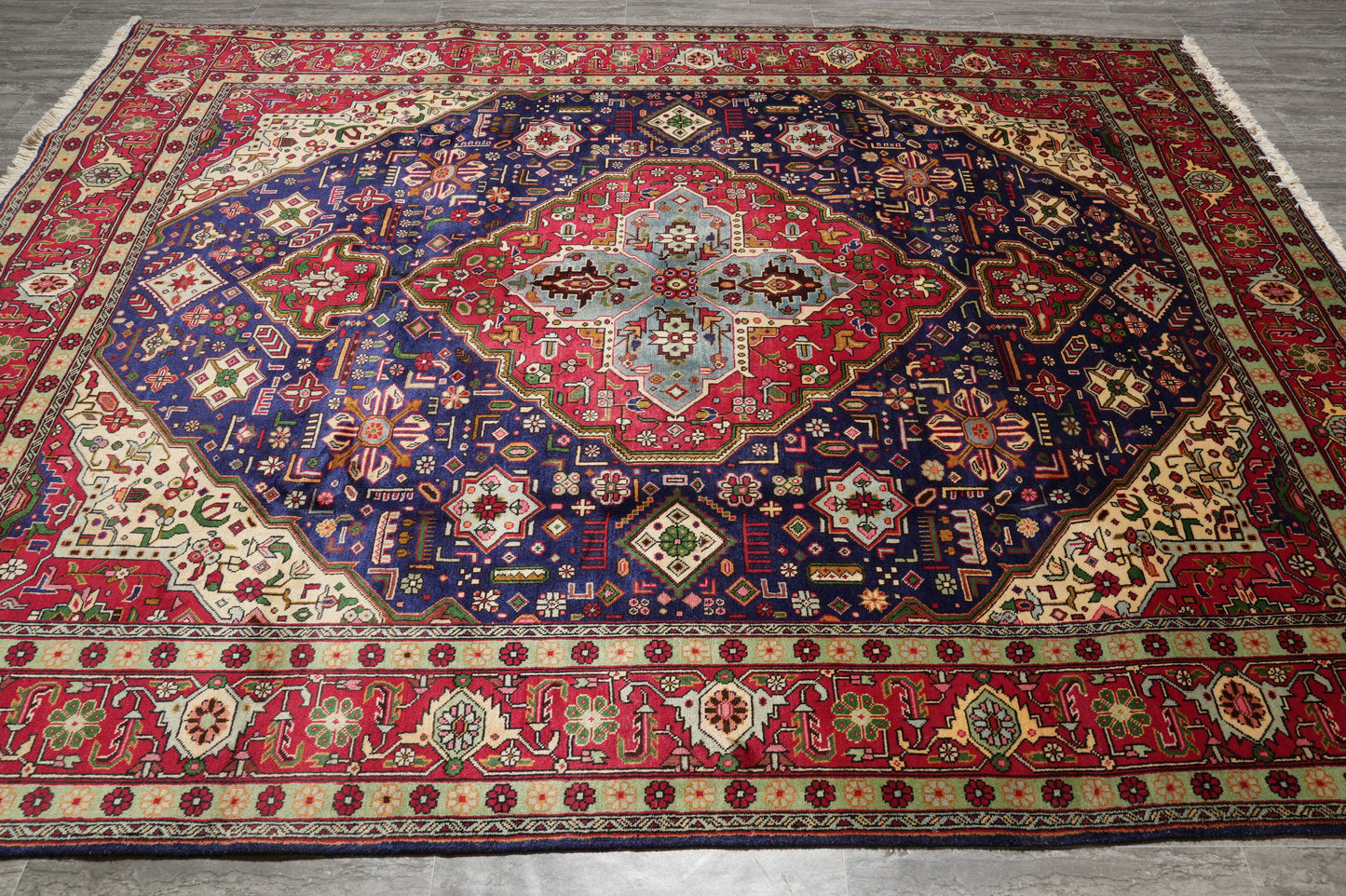 Pre-owned Tabriz-style blue rug, central medallion close-up in navy and ivory