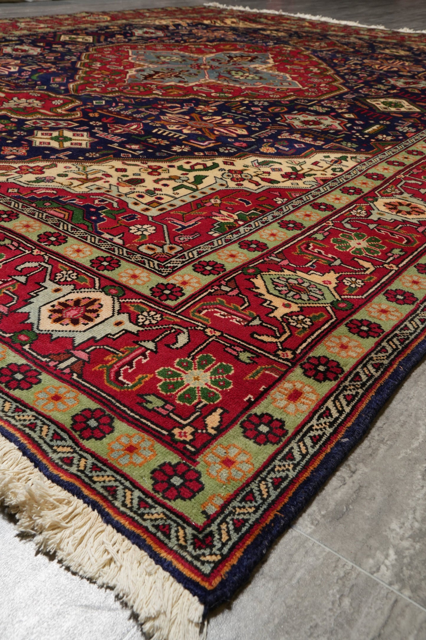 Pre-owned Tabriz-style blue rug, alternate angle showing the medallion in full