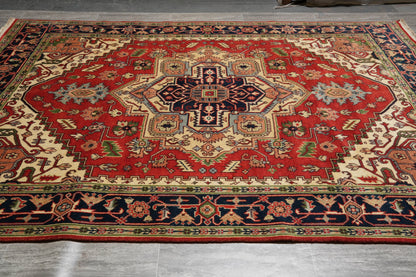 Heriz-Serapi-style rug, navy central medallion close-up on red field