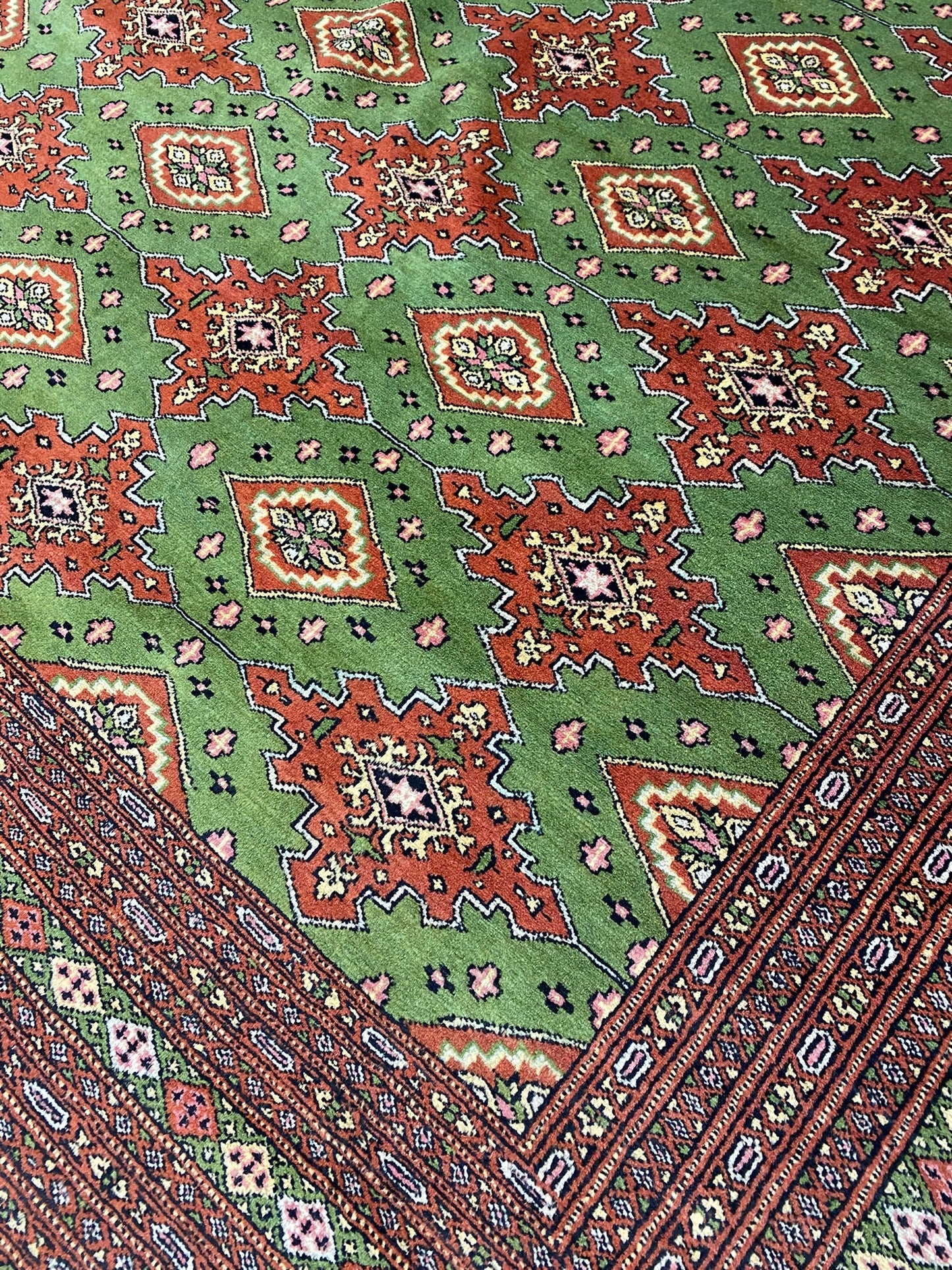 Sage green Jaldar Bokhara, alternate medallion in soft red and ivory