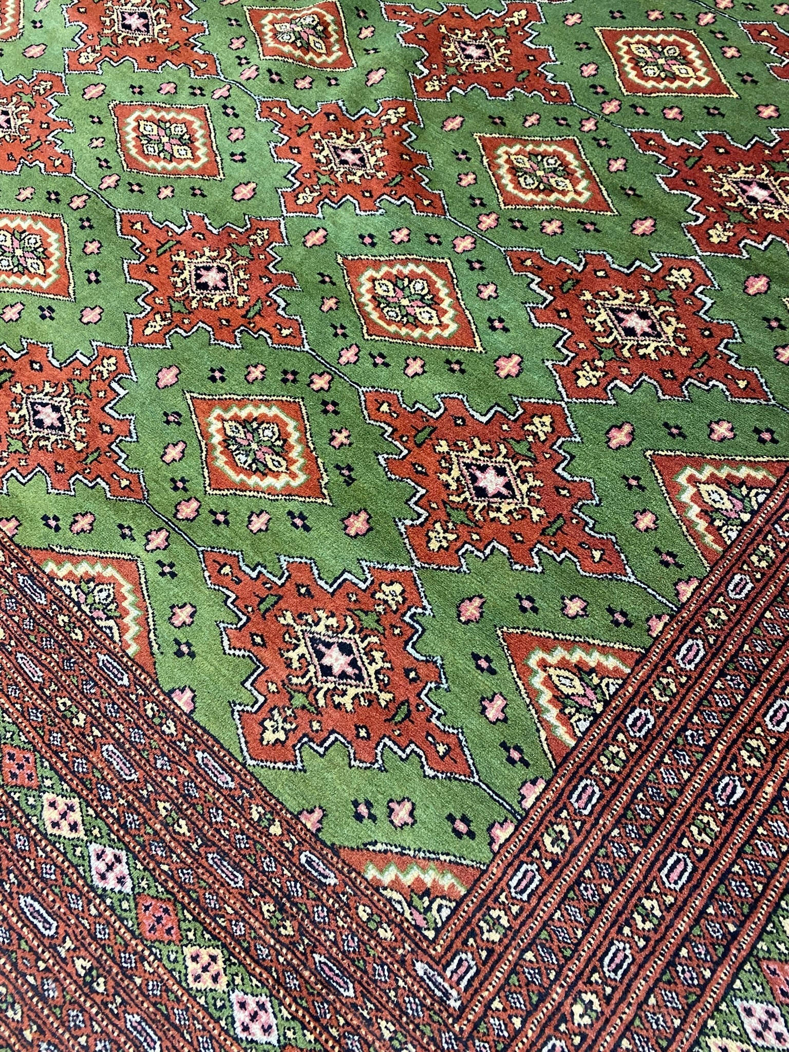 Sage green Jaldar Bokhara, alternate medallion in soft red and ivory