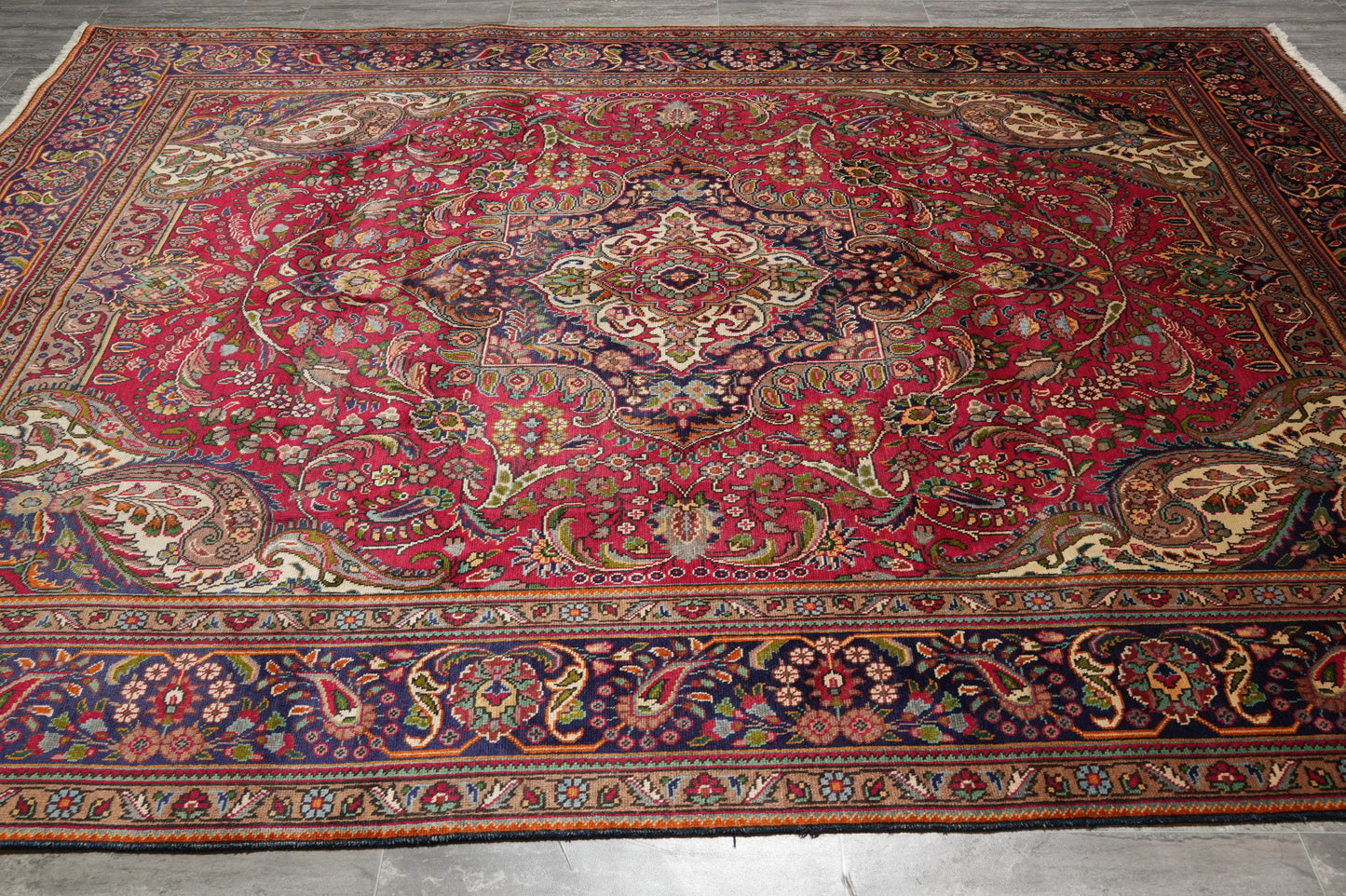 Pre-owned Tabriz-style blue rug, central medallion detail in navy and ivory
