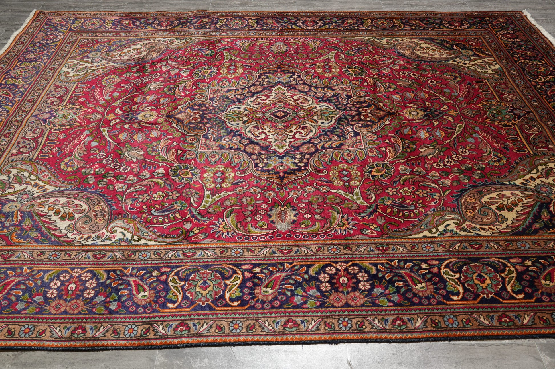 Pre-owned Tabriz-style blue rug, central medallion detail in navy and ivory