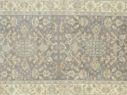 Neutral gray rug, ivory motif close-up against gray field