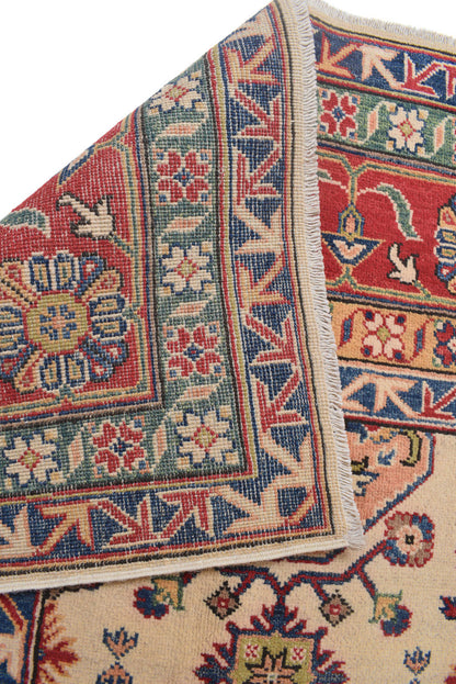 Afghan Kazak ivory rug, color balance showing ivory field against red medallions