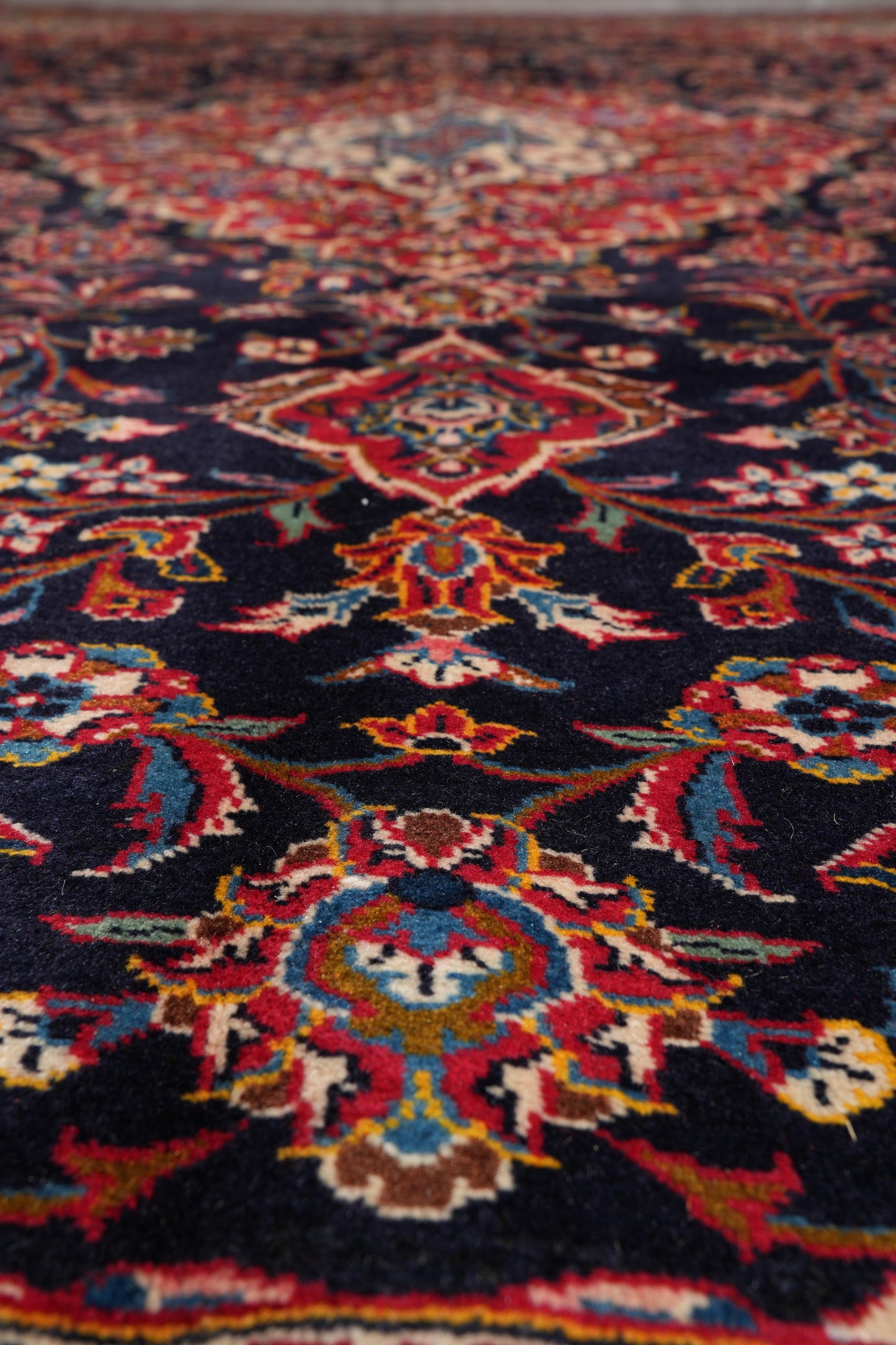 Signed Kashan-style navy rug, secondary medallion in red and ivory