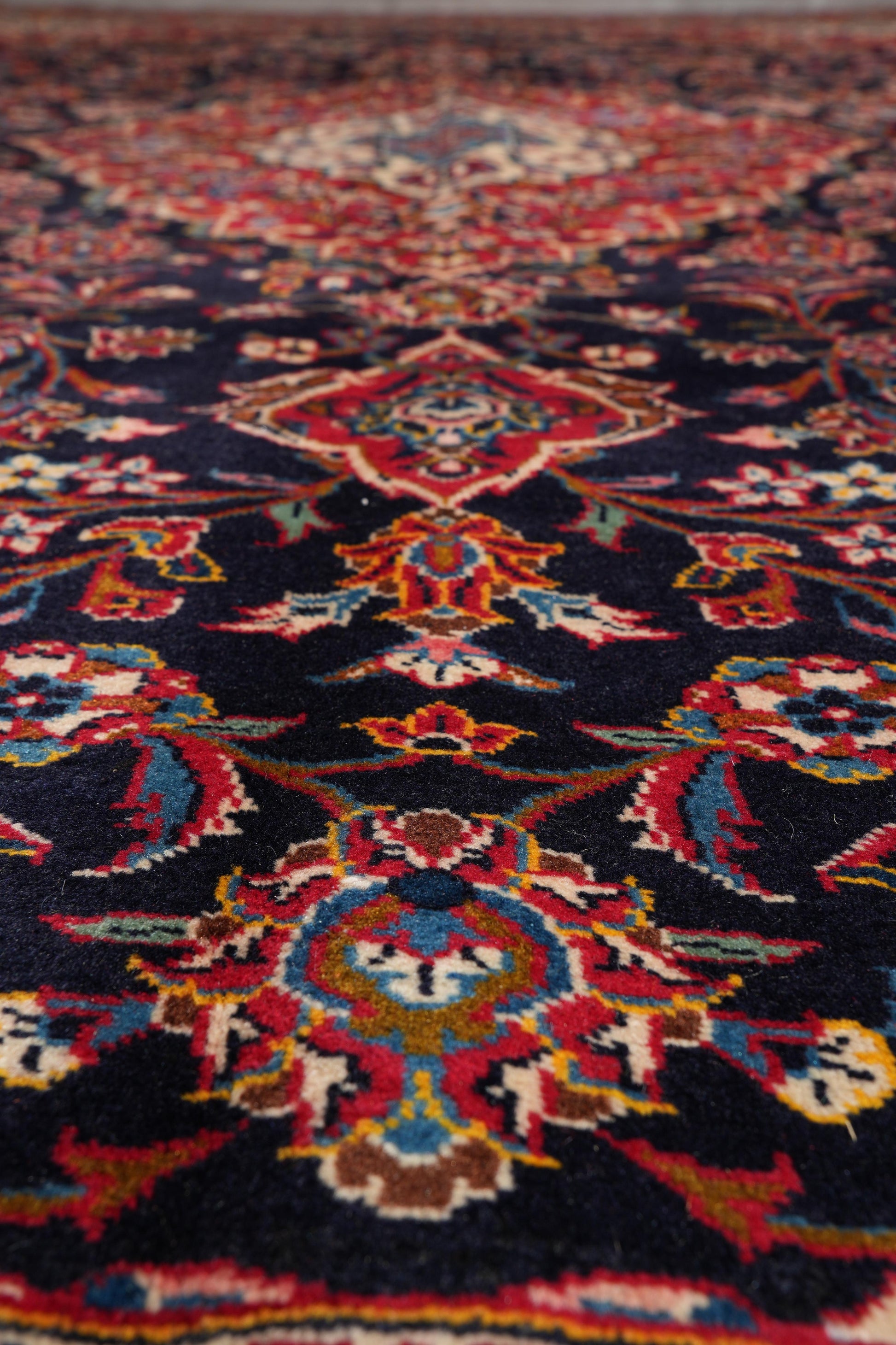 Signed Kashan-style navy rug, secondary medallion in red and ivory