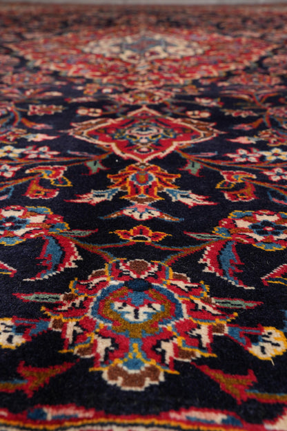 Signed Kashan-style navy rug, secondary medallion in red and ivory