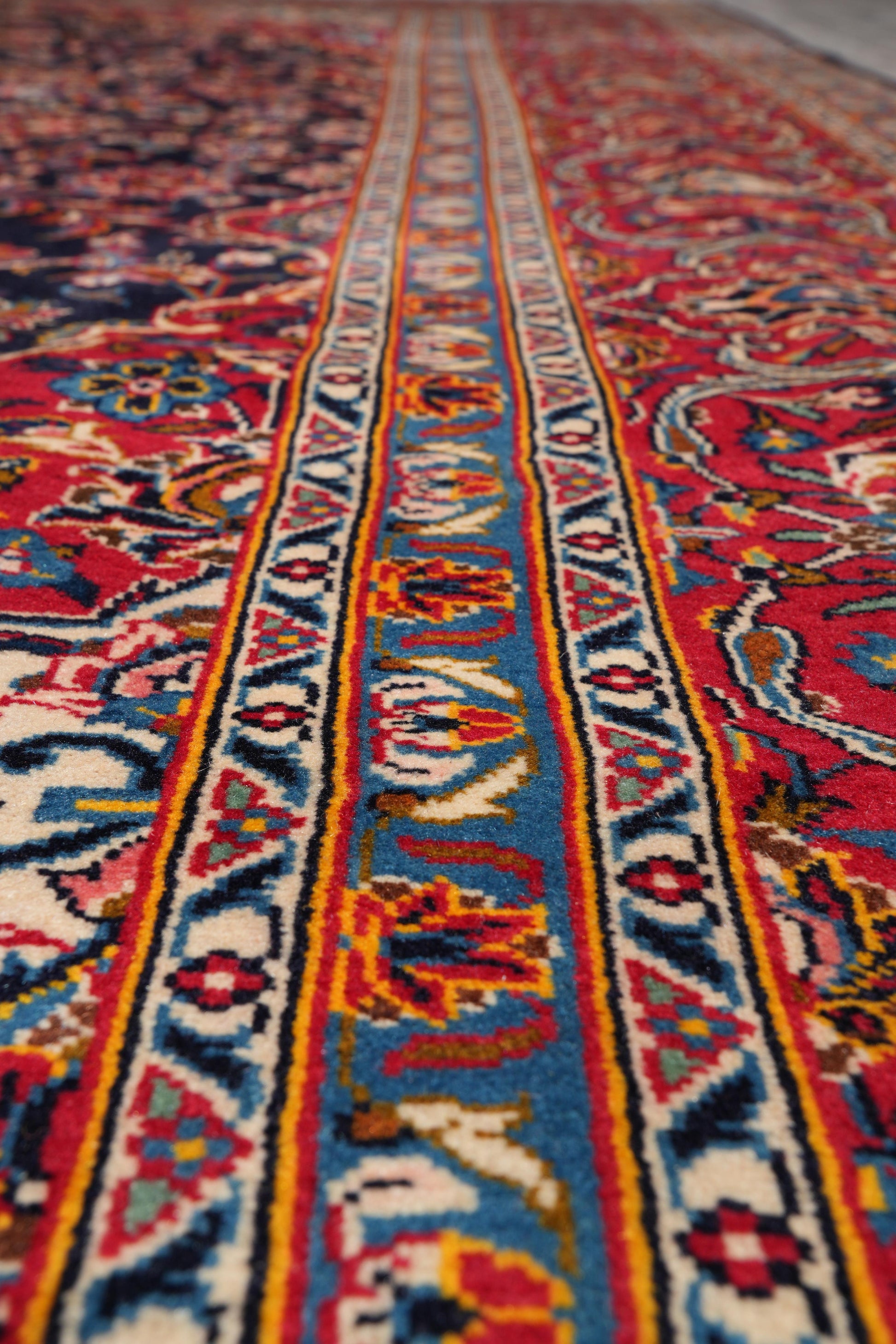 Signed Kashan-style navy rug, color balance close-up showing navy field