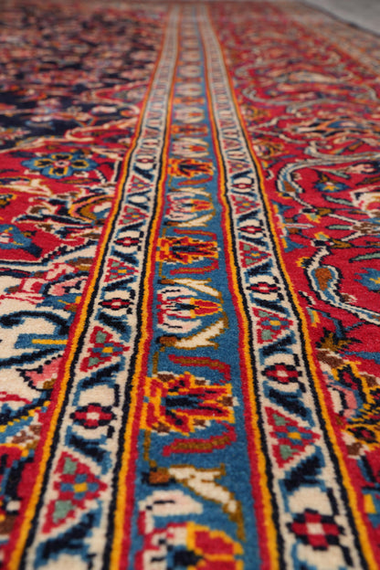 Signed Kashan-style navy rug, color balance close-up showing navy field