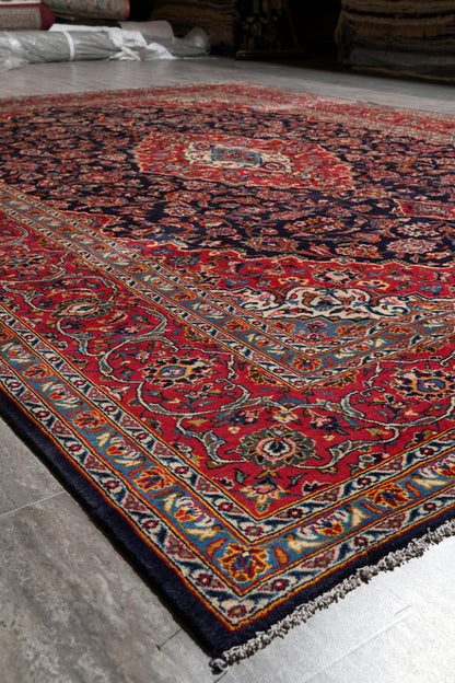 Signed Kashan-style navy rug, pile texture showing dense wool