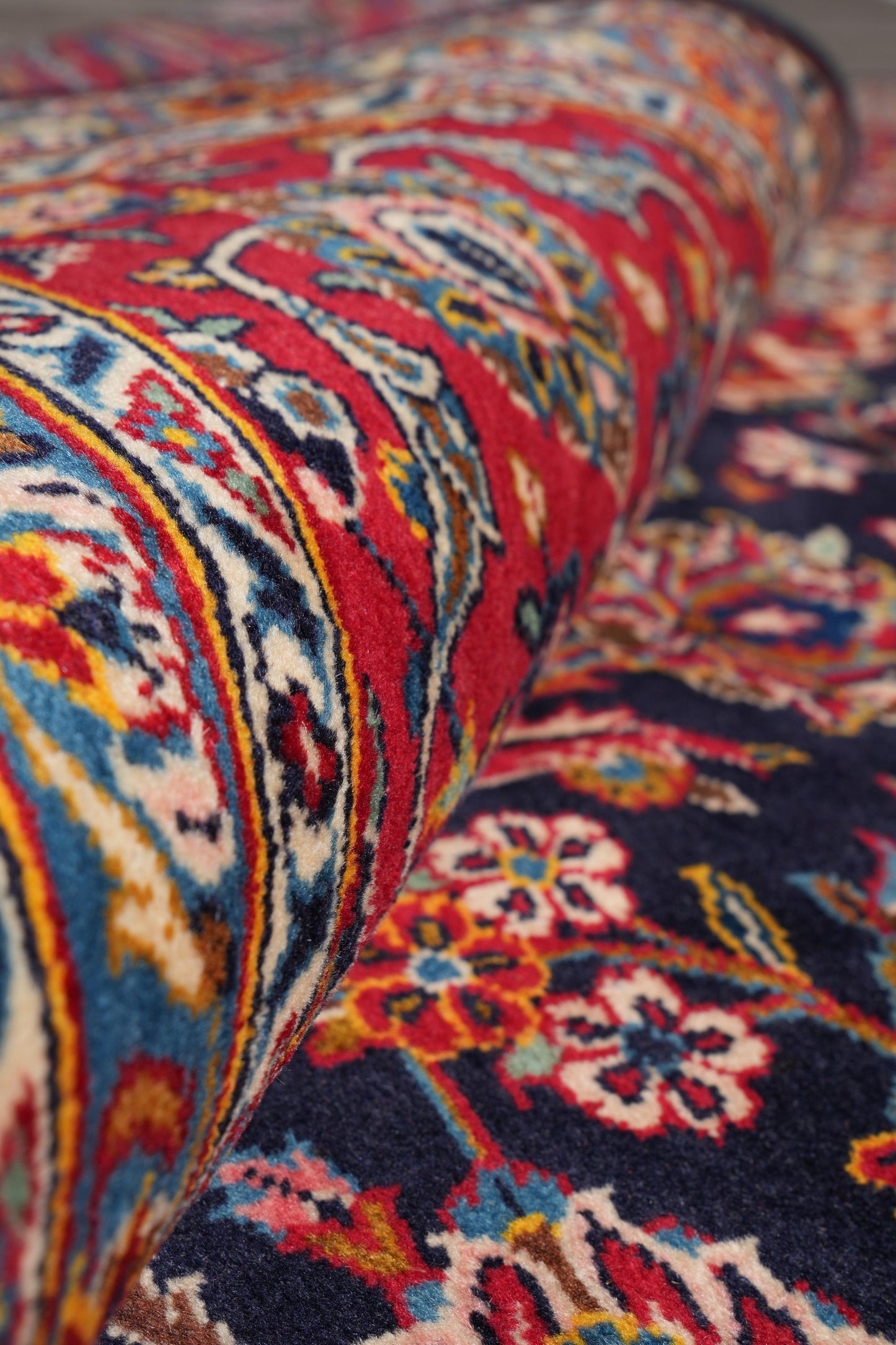 Signed Kashan-style navy rug, mid-field floral vine detail