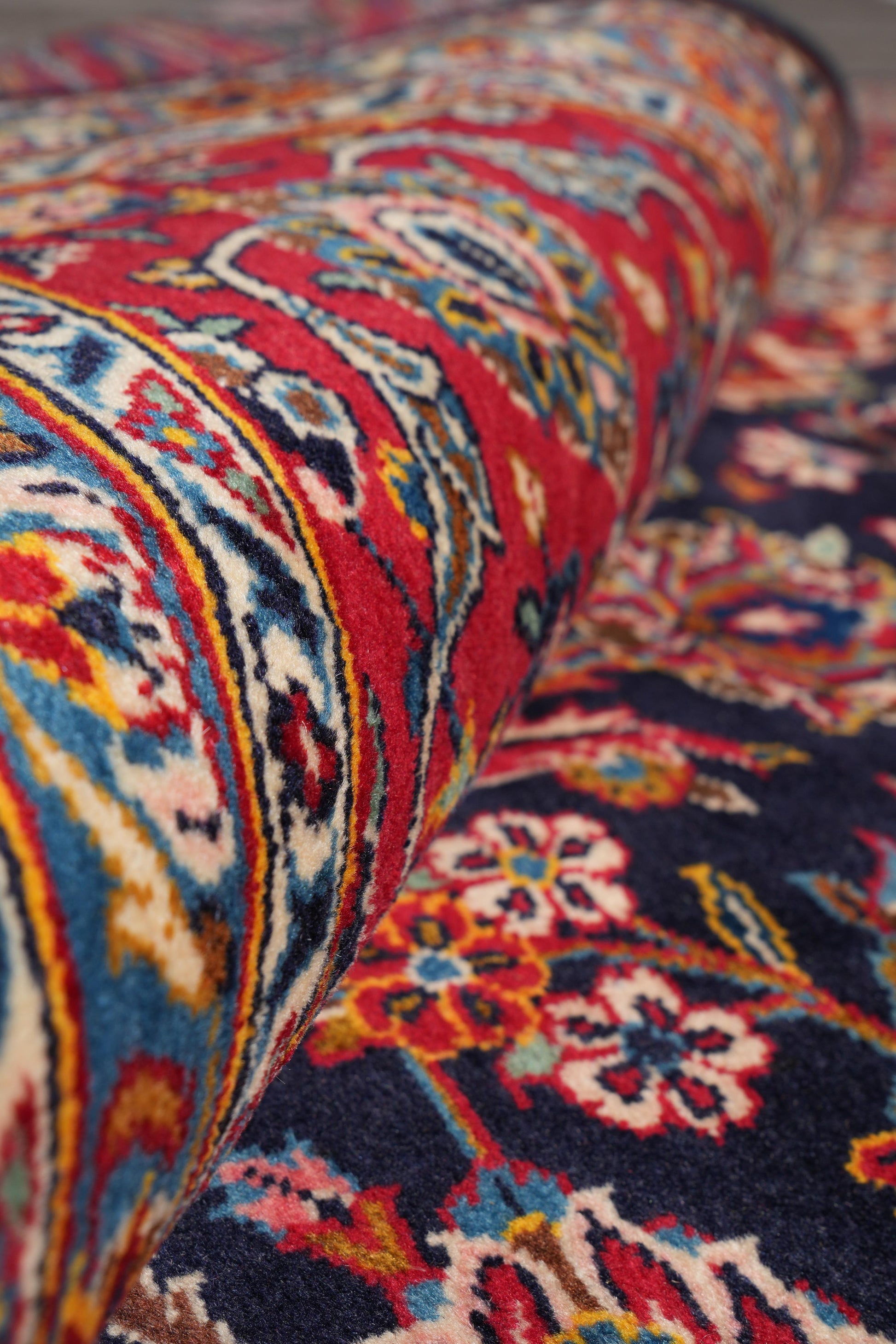 Signed Kashan-style navy rug, mid-field floral vine detail