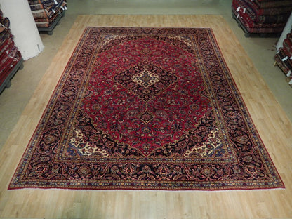 Semi-antique maroon Kashan-style rug, central floral medallion close-up