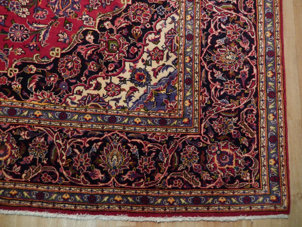 Semi-antique maroon Kashan-style rug, curvilinear floral detail