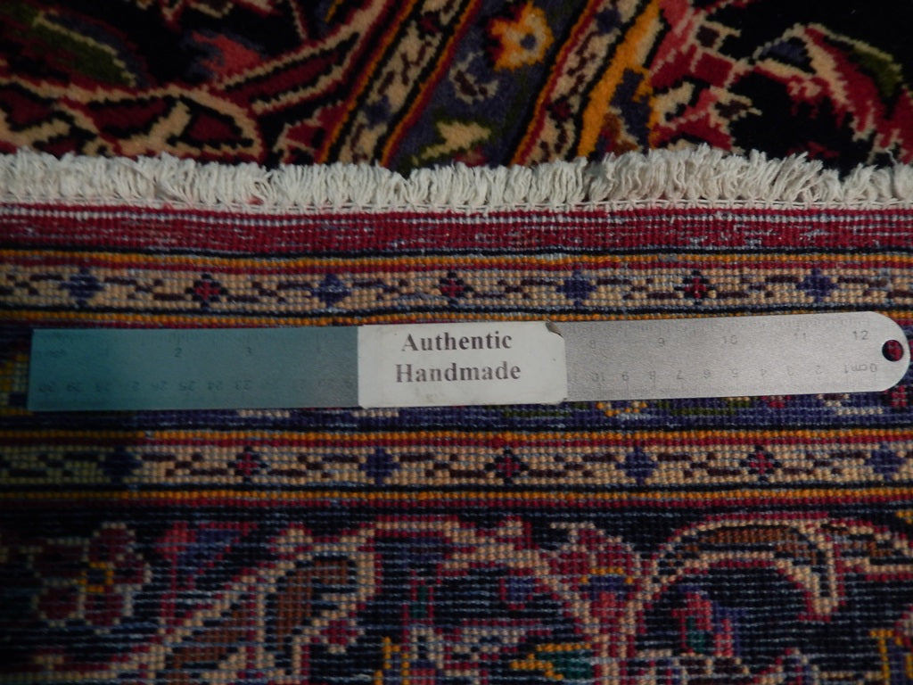 Semi-antique maroon Kashan-style rug, pile texture showing aged wool patina
