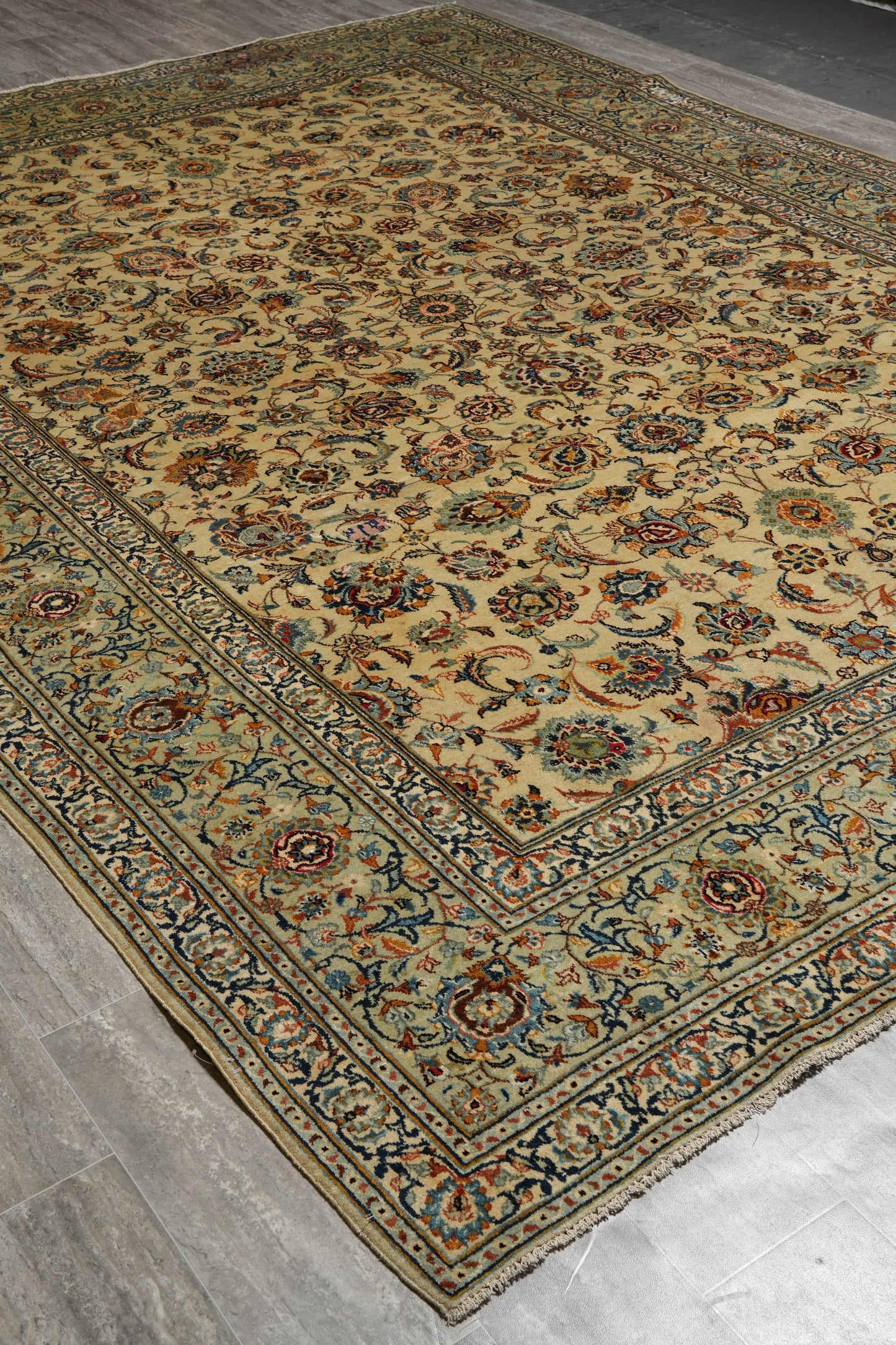 Vintage Kashan-style ivory rug, partial overhead view in natural light