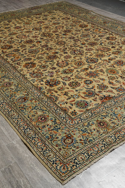 Vintage Kashan-style ivory rug, partial overhead view in natural light