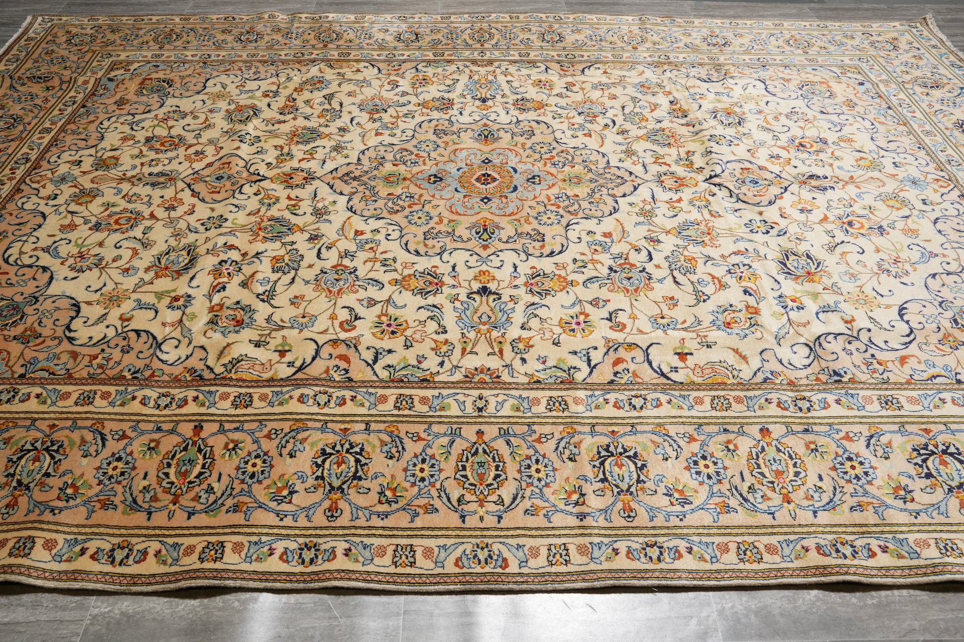 Kashan-style ivory floral rug, central medallion close-up in red and navy