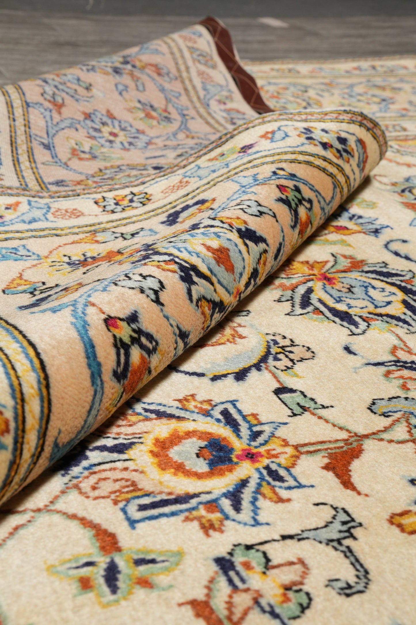 Kashan-style ivory floral rug, pile texture showing dense wool
