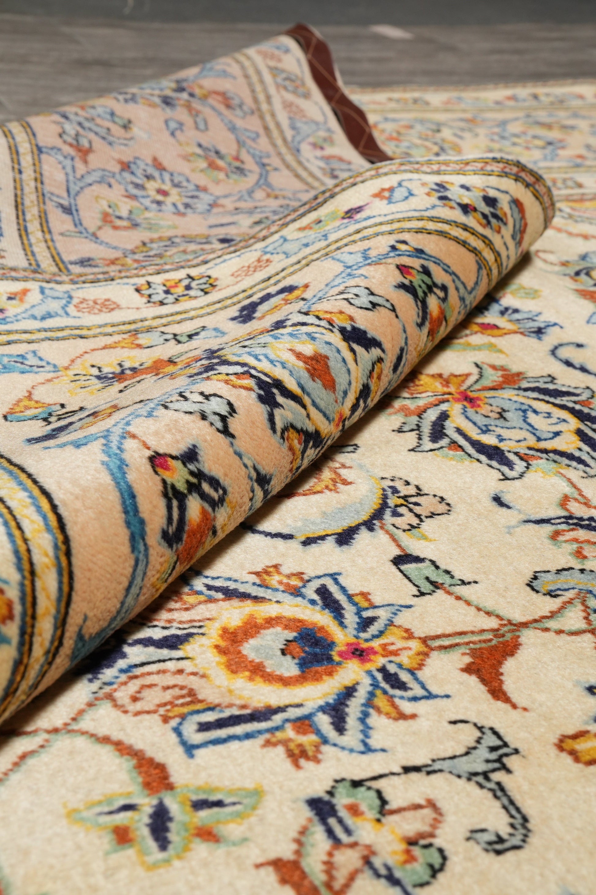 Kashan-style ivory floral rug, pile texture showing dense wool
