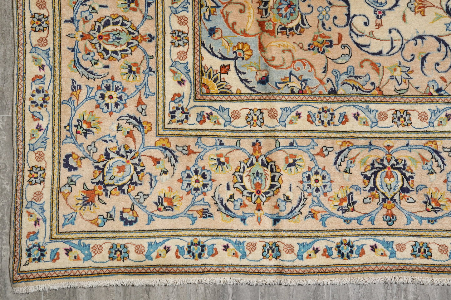 Kashan-style ivory floral rug, partial overhead view in natural light