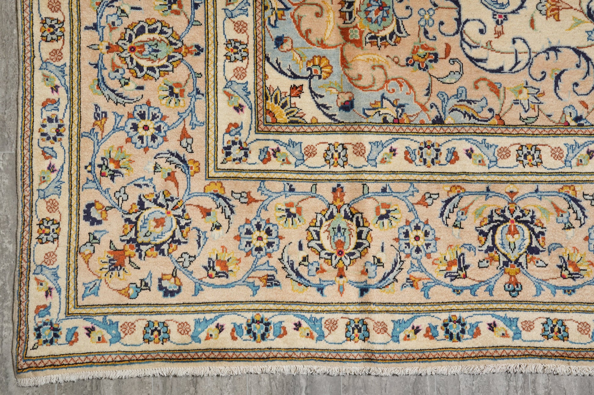 Kashan-style ivory floral rug, partial overhead view in natural light