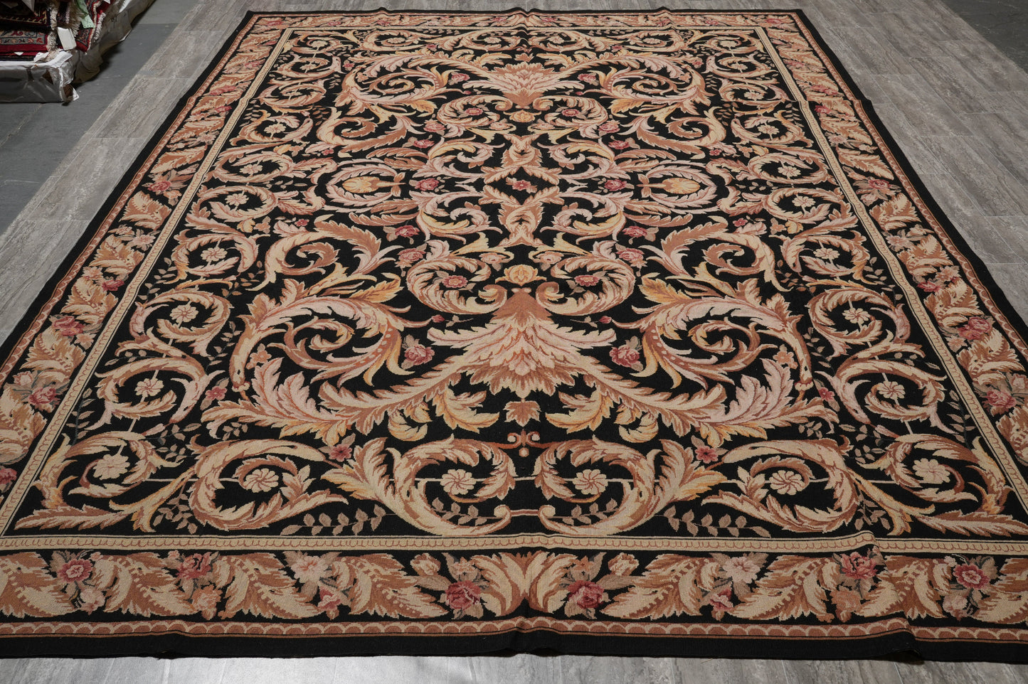 Black Aubusson rug, corner motif with curvilinear arabesques on black field
