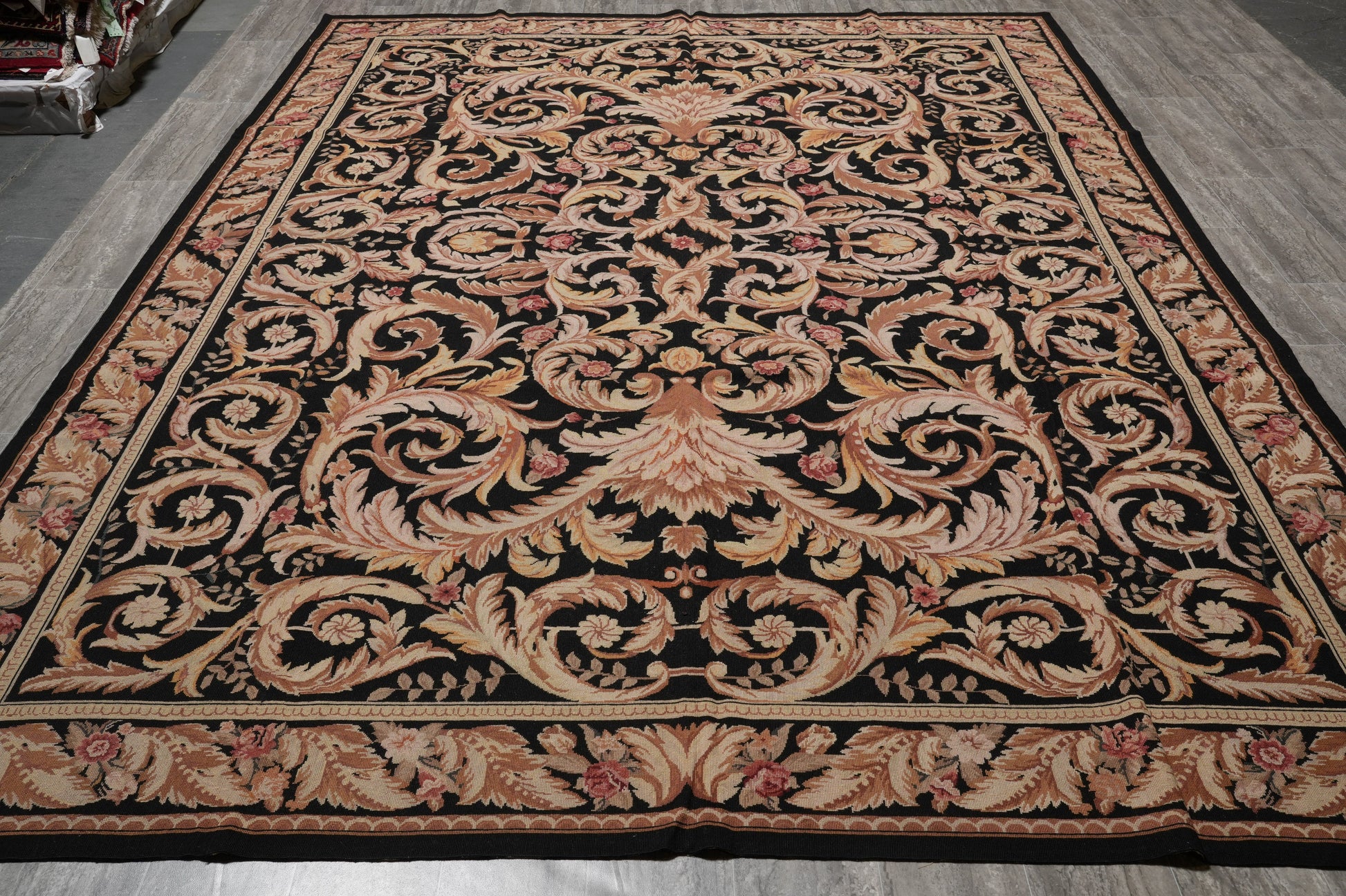 Black Aubusson rug, corner motif with curvilinear arabesques on black field
