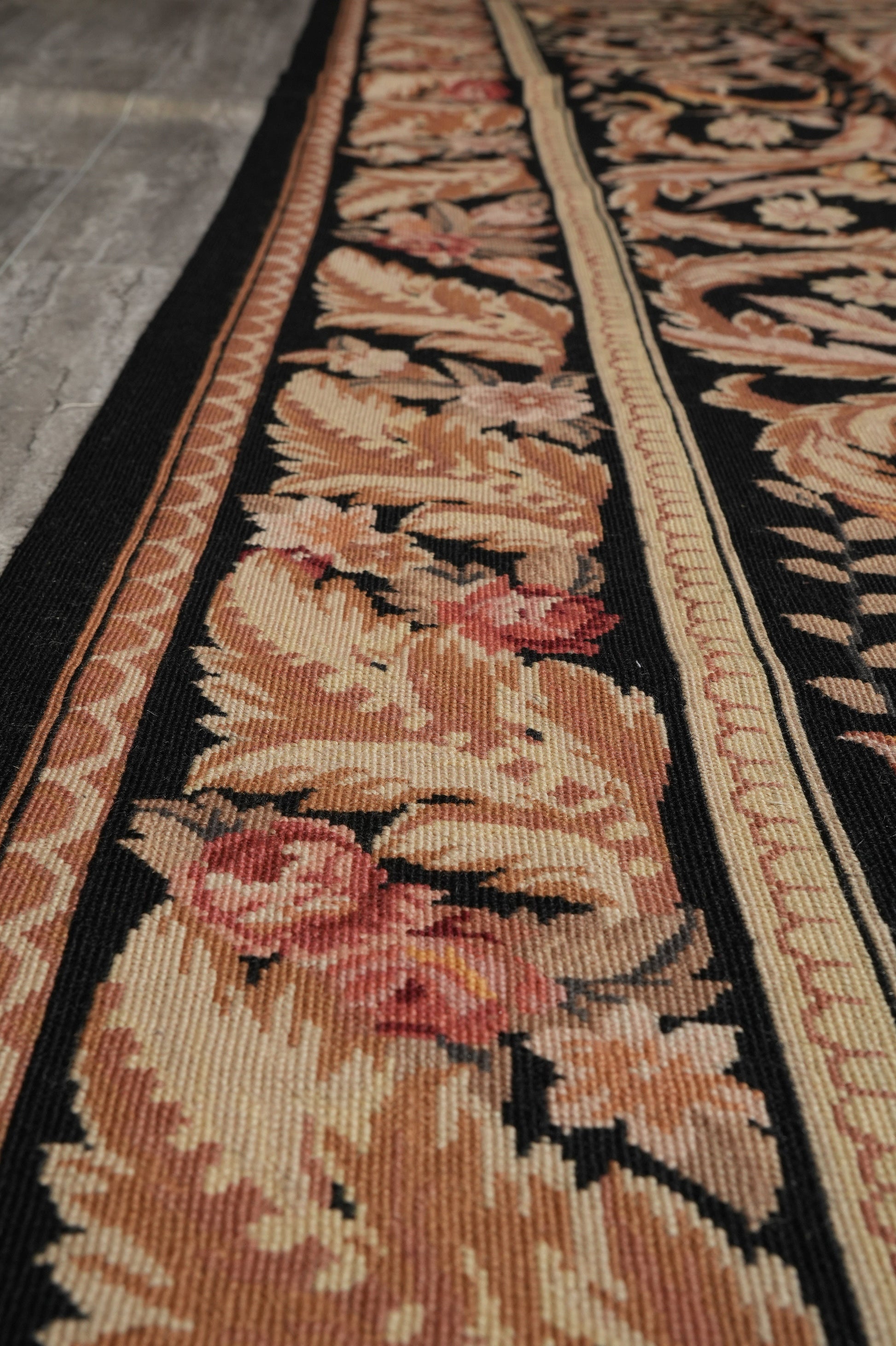 Black Aubusson rug, mid-field floral vine close-up